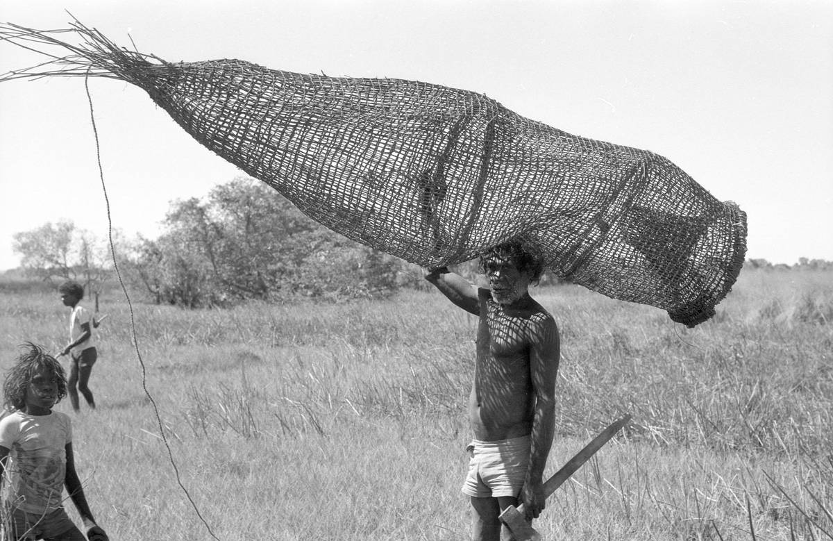 Anchor Kalunba carries a large fish trap