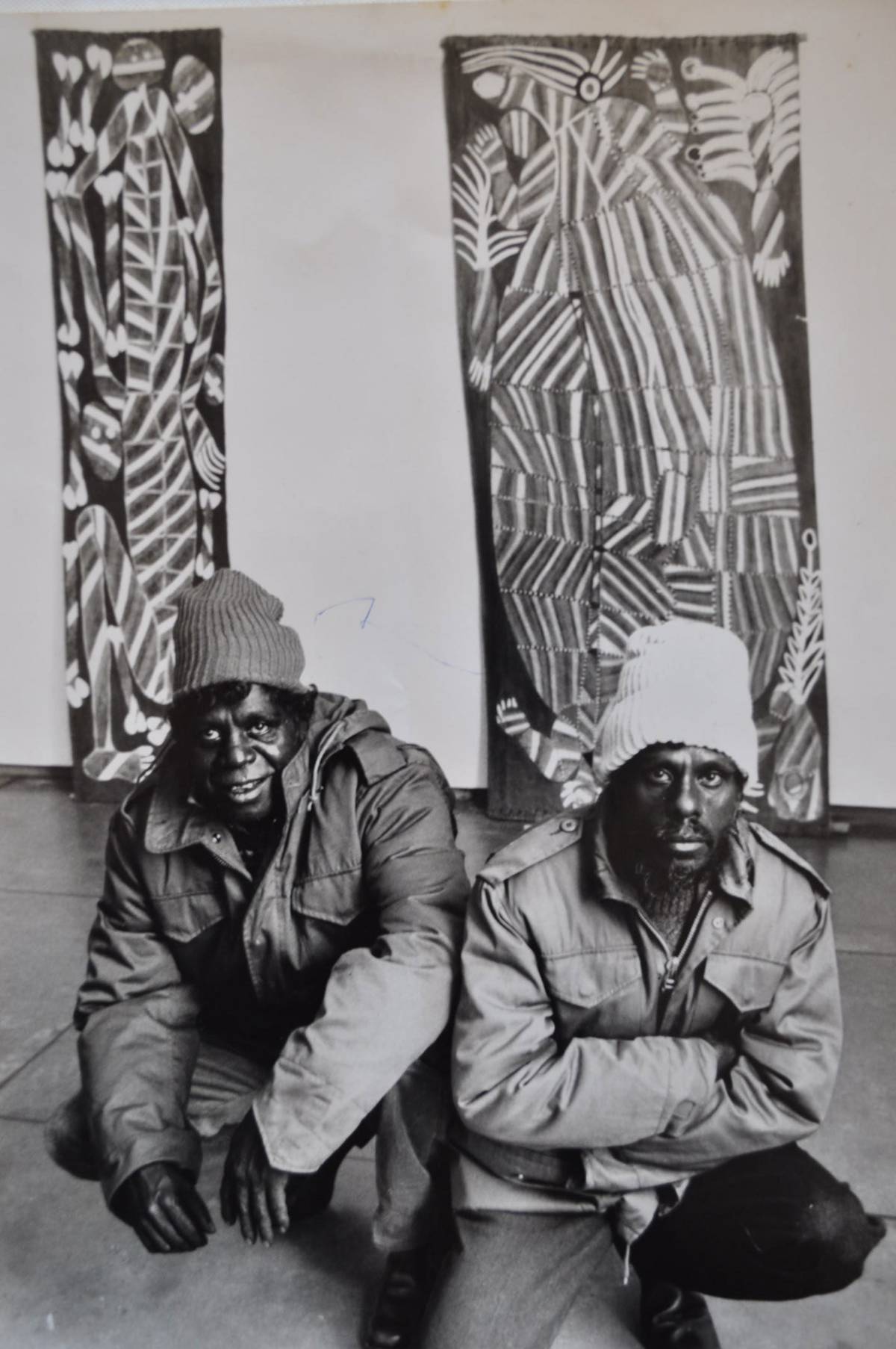 John Mawurndjul and Jimmy Njiminjuma pose in front of large bark paintings