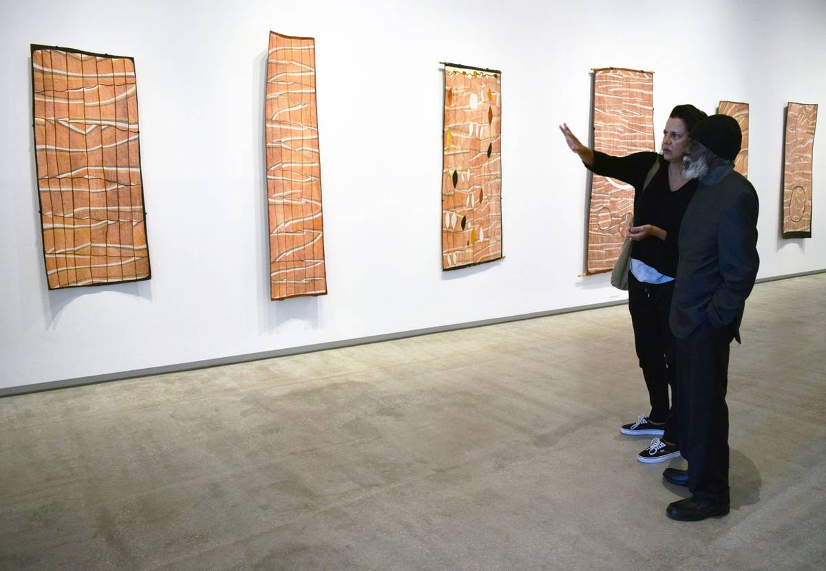 Hetti Perkins and John Mawurndjul in a gallery hung with bark paintings